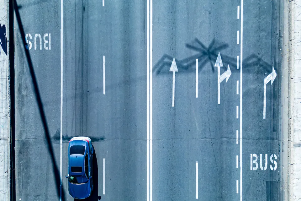 Bird's eye view of multi-lane road with dedicated bus lanes.